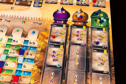Scholars of the South Tigris Board game cards with colorful symbols and numbers on a wooden surface