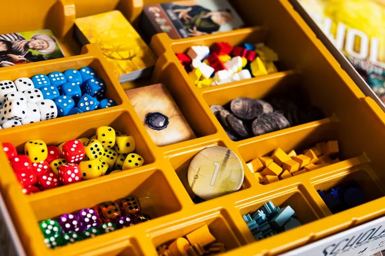 Scholars of the South Tigris Yellow compartmentalized box containing various dice and game pieces.