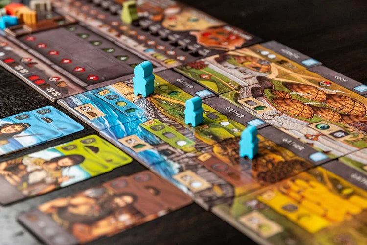Skara brae Board game with colorful tiles and player tokens on a wooden surface