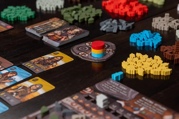Skara brae Board game components including cards, dice, and pieces on a dark surface