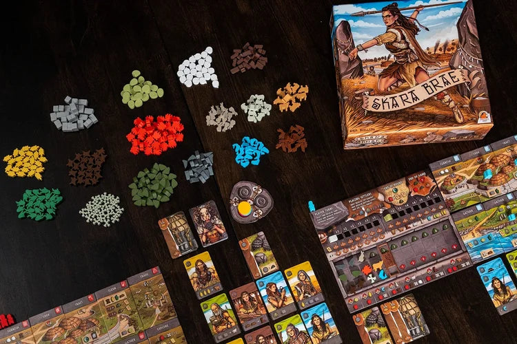 Skara brae Board game components including cards and pieces on a dark surface