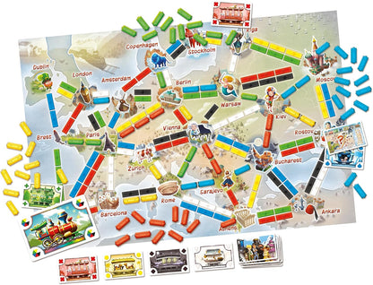 Board game with colorful train tracks and city cards on a map background
