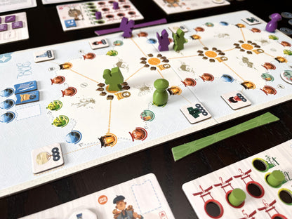 Tokaido Duo Board game in progress with colorful game pieces and cards on a dark surface