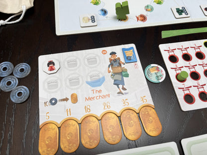 Tokaido Duo Board game components including cards and tokens on a table