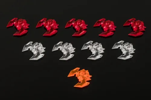 Under Falling Skies Red and clear plastic flower-shaped objects on a black background