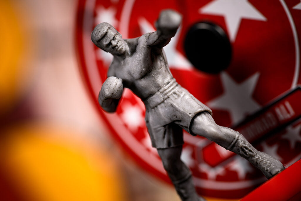 Ali boxing figure in front of a red and white circular logo