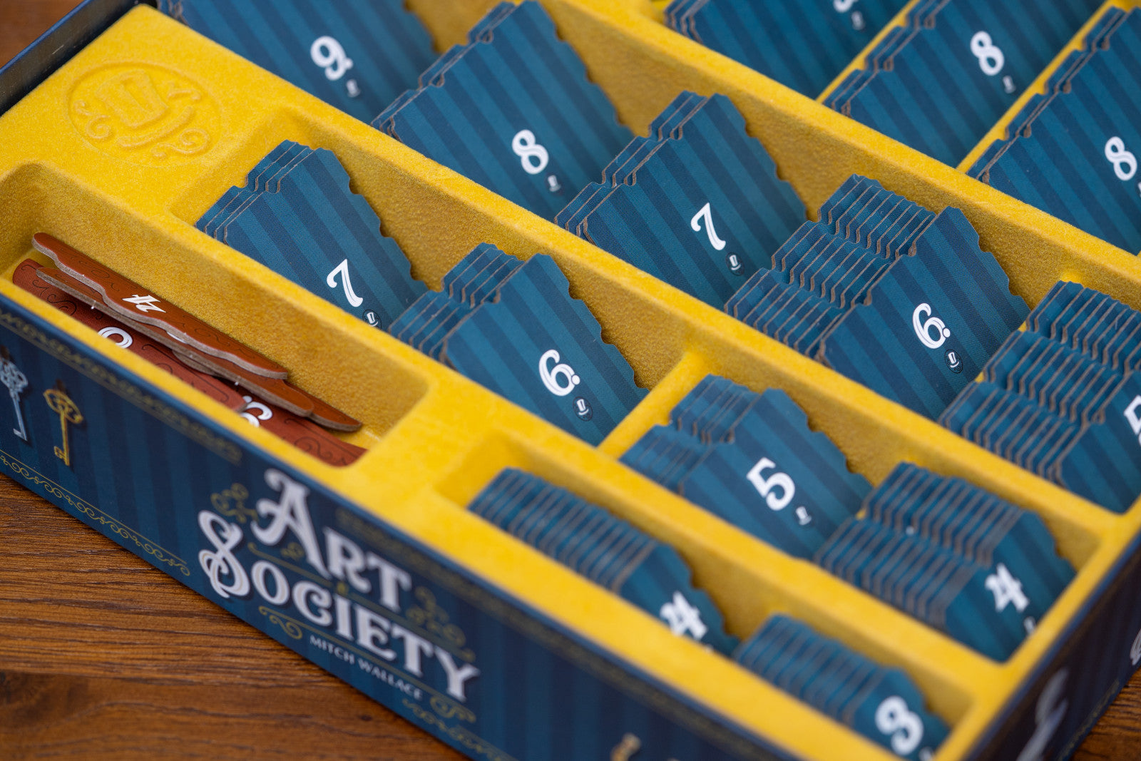 Art Society card game box with blue cards in a yellow organizer