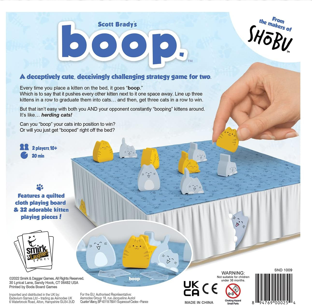 Box of Scott Brady's boop game with a hand playing the game.