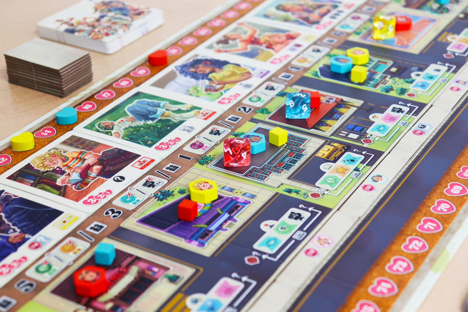 Coming of Age Board game with colorful tiles and pieces on a wooden table