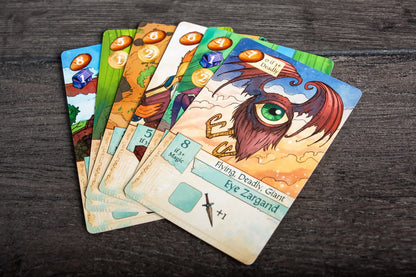 Set of fantasy-themed cards on a wooden surface