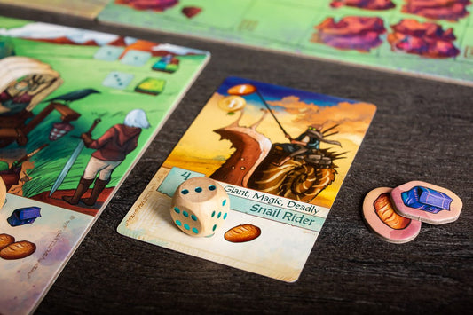 Board game cards and dice on a dark surface