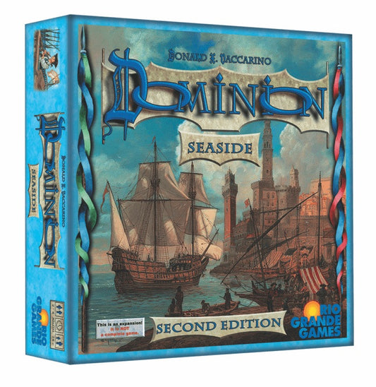 Board game box for 'Dominion Seaside' with ships and castle illustration on a blue background