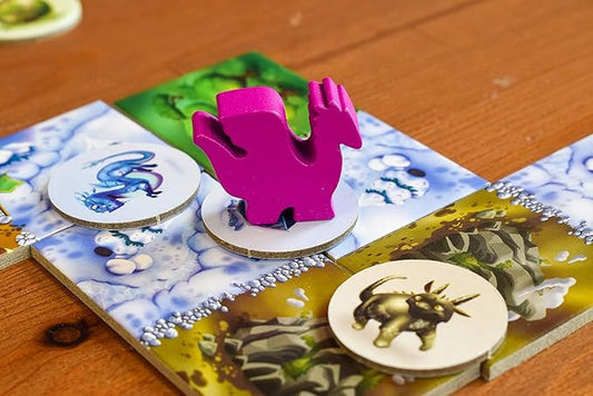 Board game piece with a pink dinosaur figure on a game board with animal illustrations.