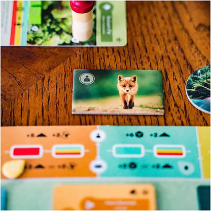 Earth Card with a fox illustration on a wooden surface with other cards around.