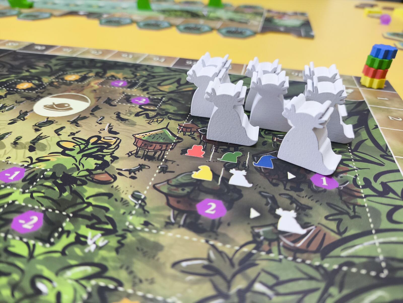 Board game with white figurines on a colorful game board