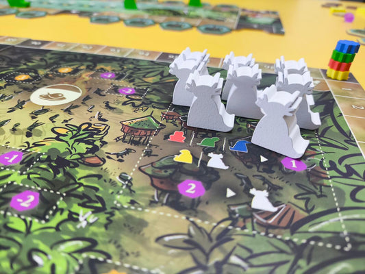 Board game with white figurines on a colorful game board