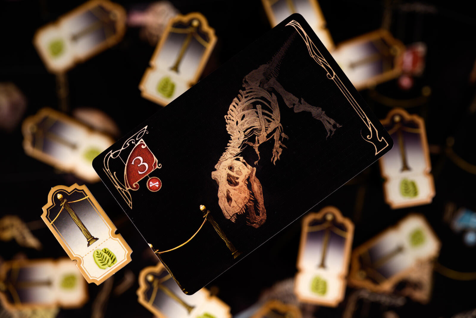 Card with dinosaur skeleton design on a dark background