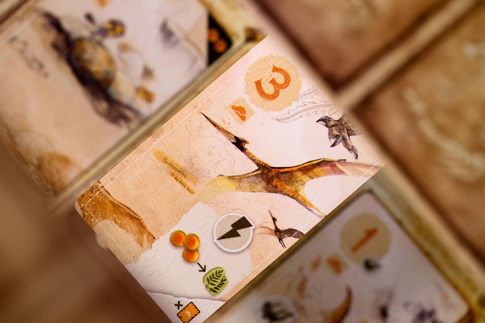 Close-up of a card game with cards featuring illustrations and numbers.