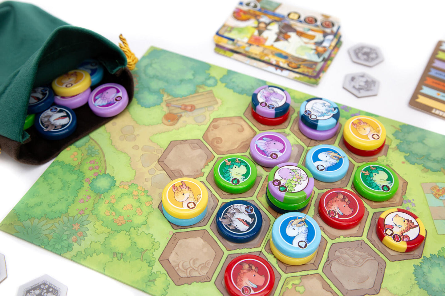 Board game Flamecraft duals with colorful game pieces on a green playing mat