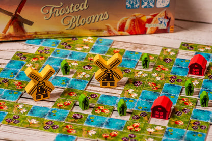 Board game with windmills and houses on a wooden surface