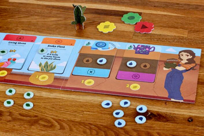 Board game with colorful tiles and character illustration on a wooden surface