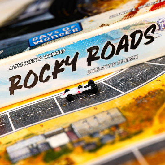 Board game box for 'Rocky Roads' by Days of Wonder with a miniature car on the road.