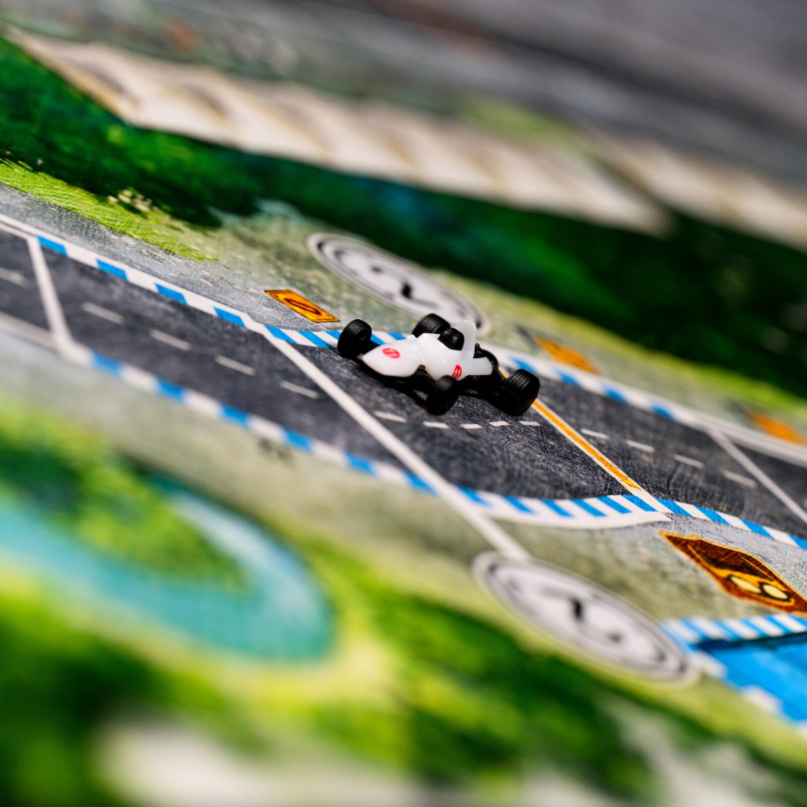 Model race car on a miniature racing track with blurred background