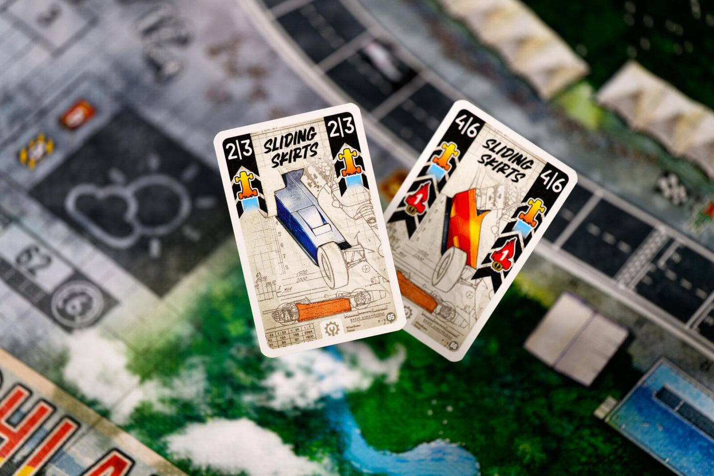 Two playing cards with 'Sliding Spirits' design on a board game surface.
