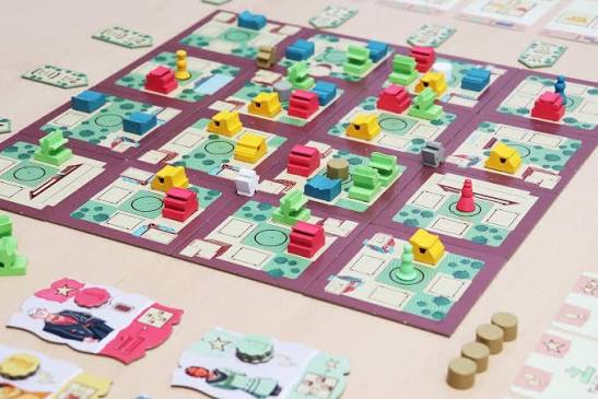 set up board game with pieces on a patterned mat.