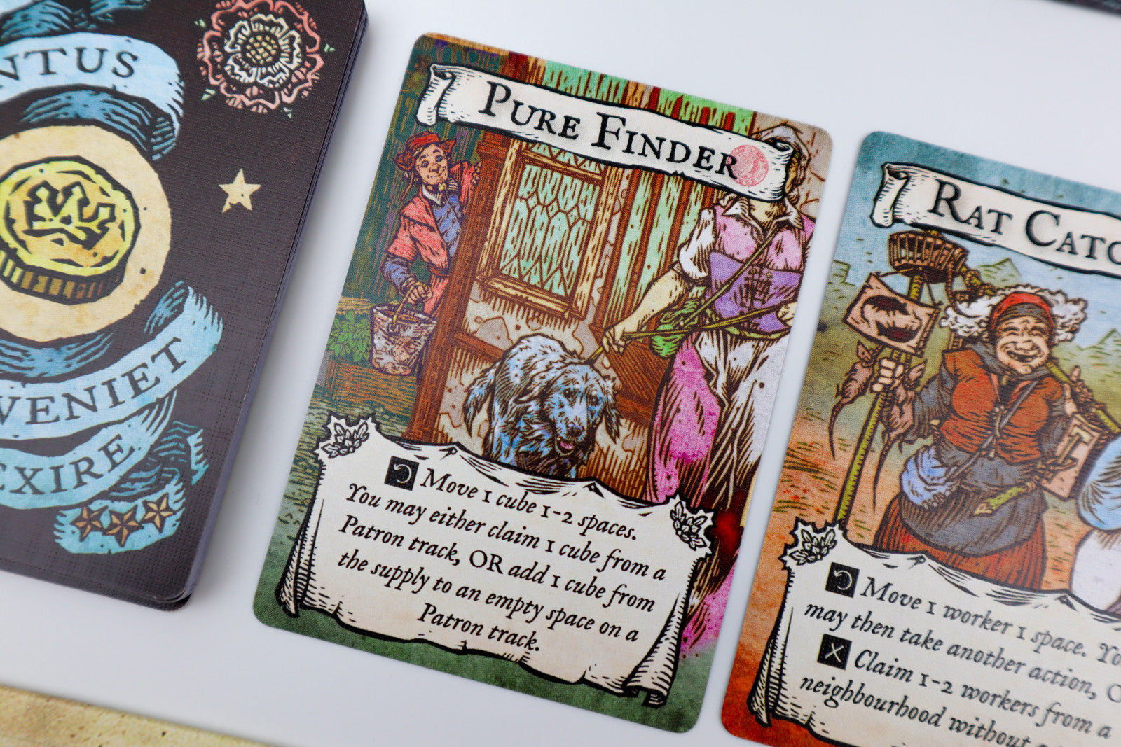 Card game cards with illustrations and text on a white surface