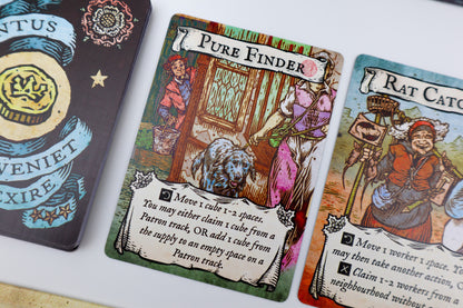 Card game cards with illustrations and text on a white surface