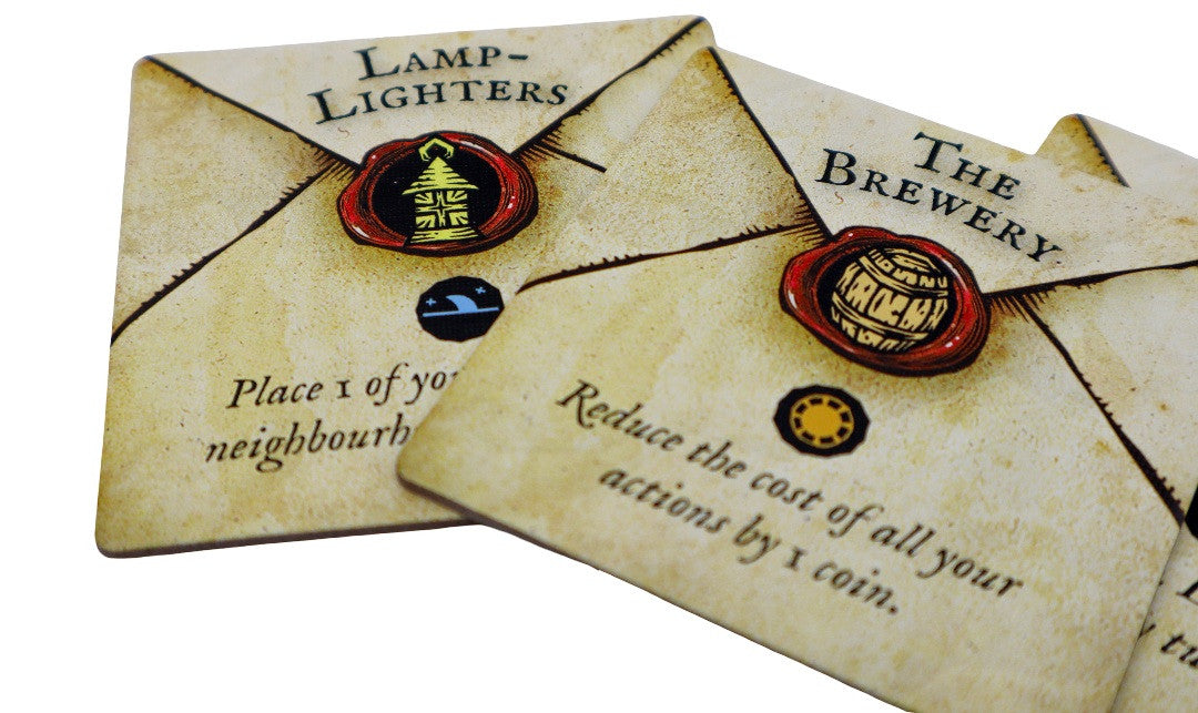 Two vintage-style cards with text and seals, resembling game tokens or collectibles.