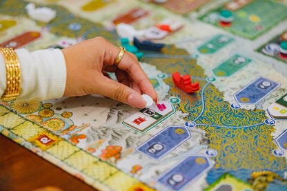 River of Gold board game with colorful pieces on a detailed board