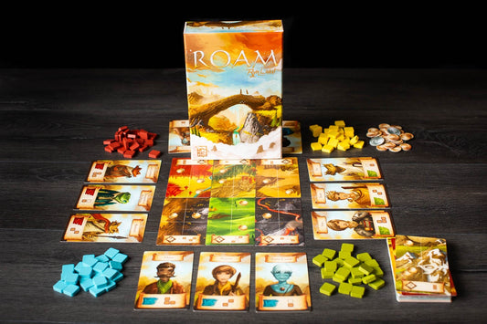 Board game 'Roam' with cards, tokens, and box on a dark surface