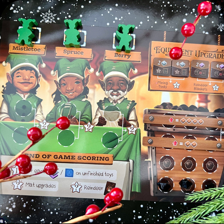 A close-up of a handmade scrapbook or card featuring a Christmas-themed board game design. The design includes three elf characters labeled Mistletoe, Spruce, and Berry in green outfits, a scoring board, and a wooden chest with red berries as decorative elements.