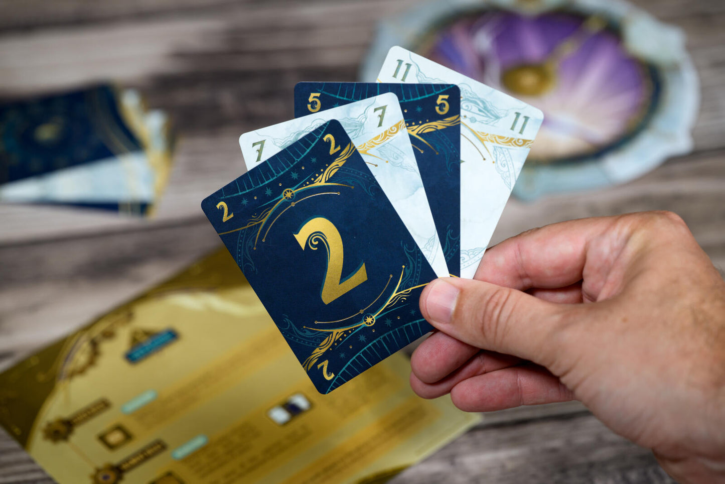 Take Time board game with Hand holding tarot cards with a blurred background