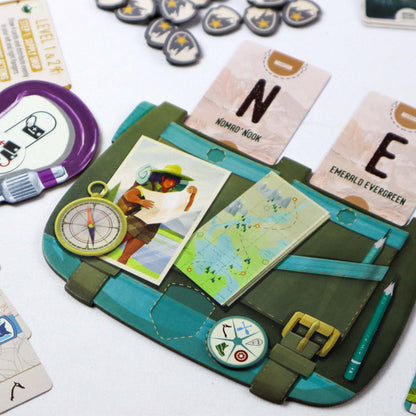 Peak Team Board game components including cards and a map on a green and blue game board.