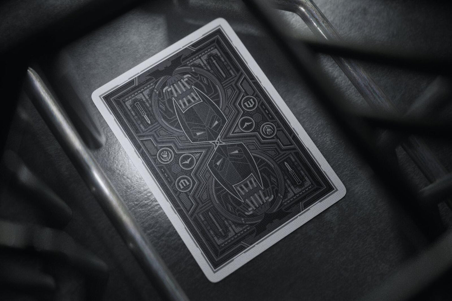 Batman playing cards with intricate design on a dark surface