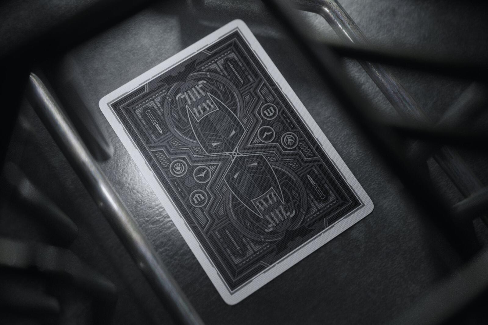 Batman playing cards with intricate design on a dark surface