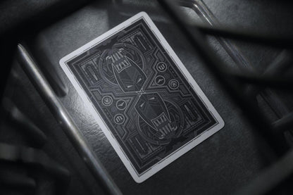 Batman playing cards with intricate design on a dark surface