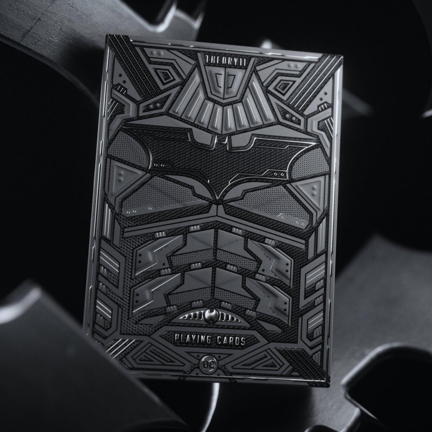 Batman playing cards of Black and gray playing card box with geometric design on a dark background