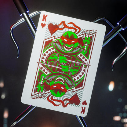 Playing card with a green character design on a dark background