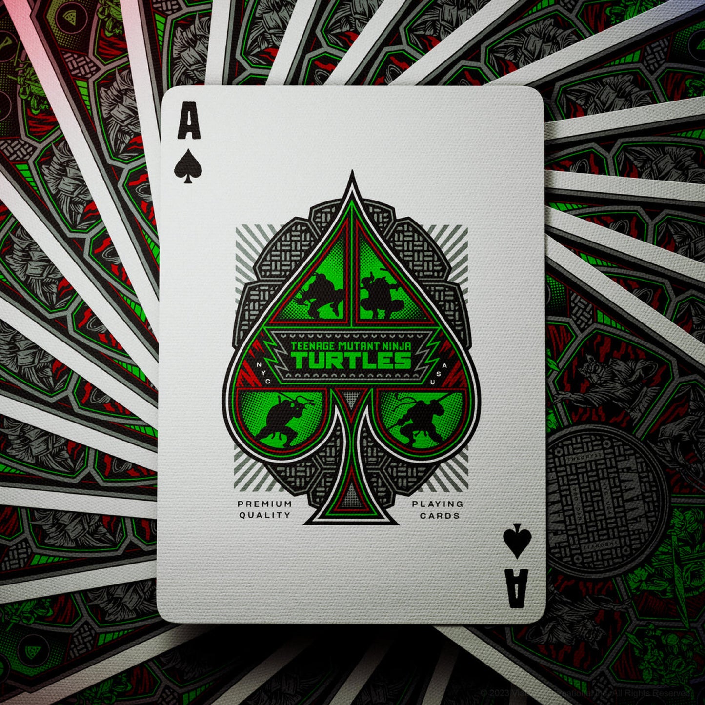 Ace of Spades playing card with Teenage Mutant Ninja Turtles design on a fan of cards background.