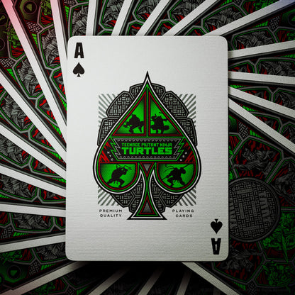 Ace of Spades playing card with Teenage Mutant Ninja Turtles design on a fan of cards background.