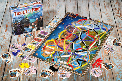 Board game 'Ticket to Ride' northern lights with colorful train maps and cards on a wooden surface