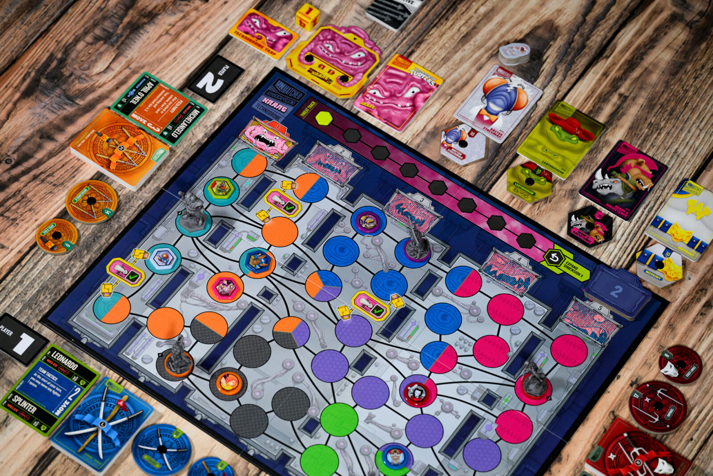 Teenage Mutant Ninja Turtles Colorful board game with cards and pieces on a wooden surface
