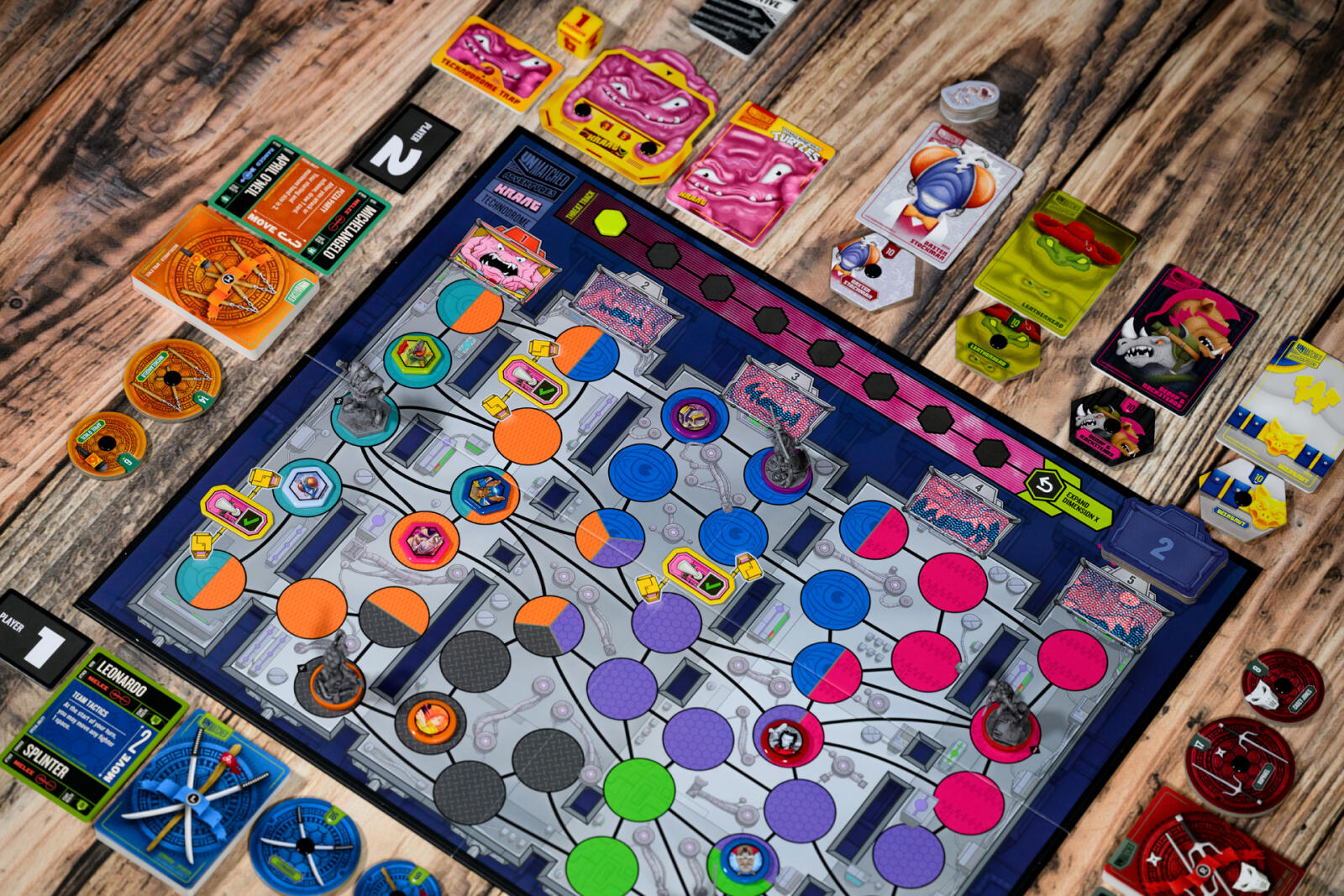 Teenage Mutant Ninja Turtles Colorful board game with cards and pieces on a wooden surface