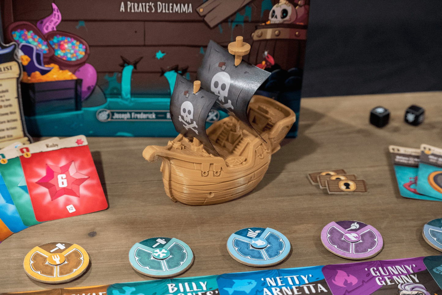 Pirate-themed board game with ship and cards on a wooden surface