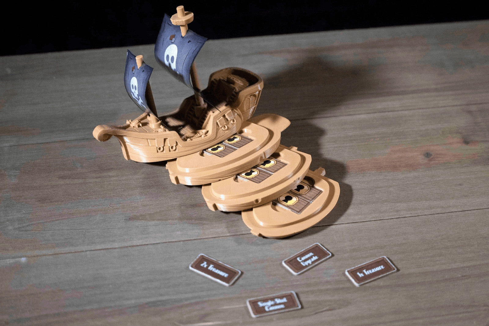 Wooden toy ship with cards on a wooden surface