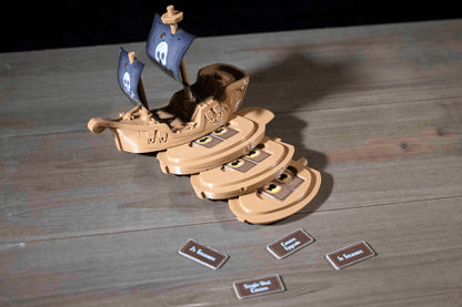 Wooden toy ship with cards on a wooden surface